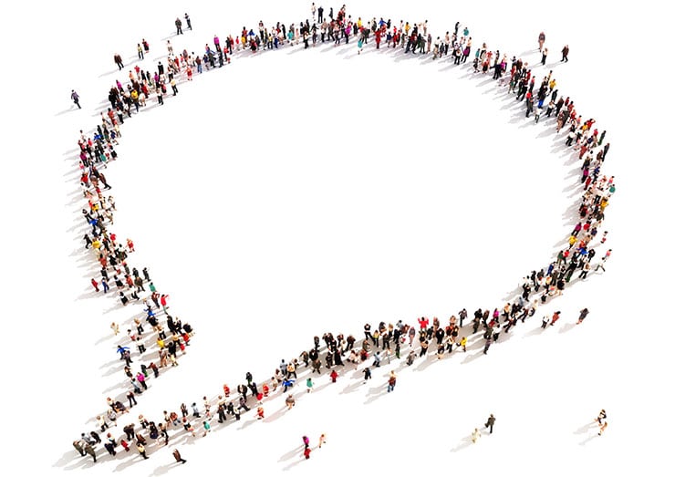 Large group of people in the shape of a chat bubble